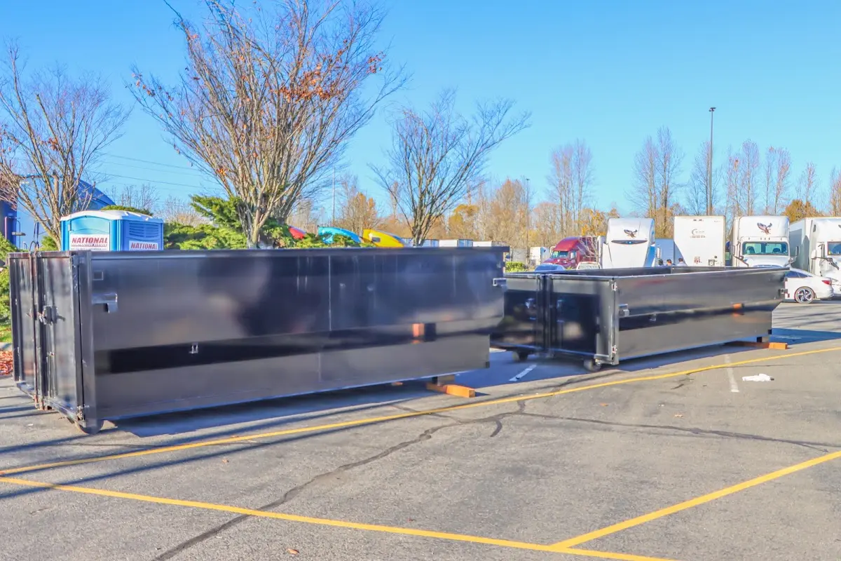 Professional dumpster rental service with roll-off container on residential driveway in Goodyear